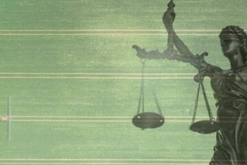 Lady justice blending in on top of an aerial view of a monoculture with a tractor spraying pesticides.